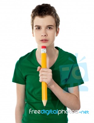 Thinking School Boy Holding Pencil Stock Photo