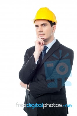 Thoughtful Architect Wearing A Hard Hat Stock Photo