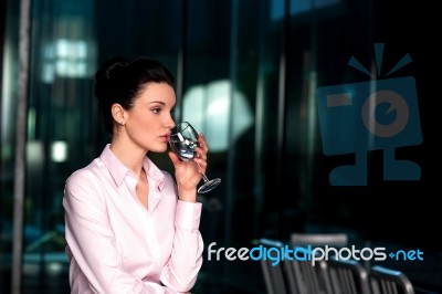 Thoughtful Corporate Woman Drinking Water Stock Photo