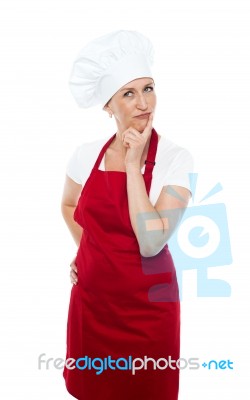 Thoughtful Female Chef Standing Stock Photo