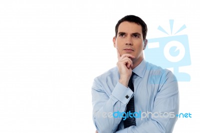 Thoughtful Middle Aged Business Man Looking Up Stock Photo