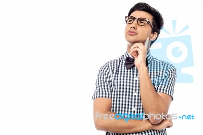 Thoughtful Young Man Looking Up Stock Photo