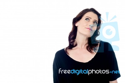 Thoughtful Young Woman Looking Up Stock Photo