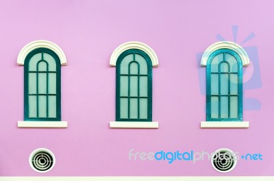 Three Green Arched Windows On Pink Wall Stock Photo