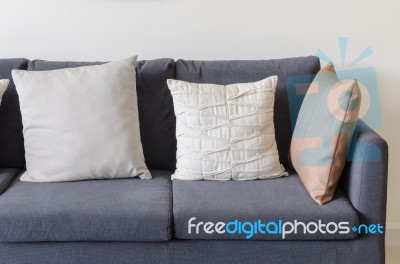 Three Of Pillows On Dark Blue Sofa Stock Photo