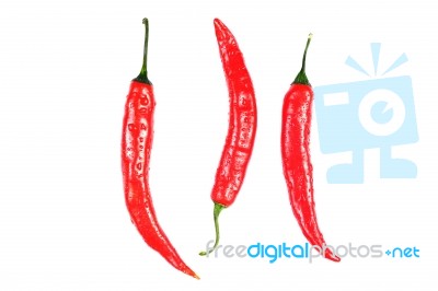 Three Red Peppers Over White Background Closeup Stock Photo