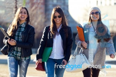 Three Students Girls Walking In The Campus Of University Stock Photo