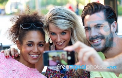 Three University Students Taking A Selfie In The Street Stock Photo