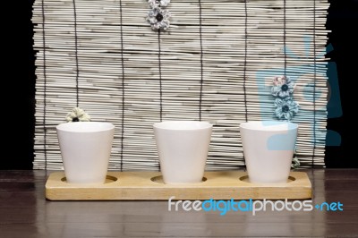 Three White Cups With Bamboo Backdrop Stock Photo