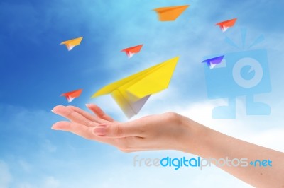 Throwing Paper Plane In Sky Stock Photo