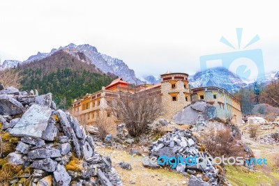 Tibetan Temple On The Snow Mountain  With Gray Rocks Stock Photo