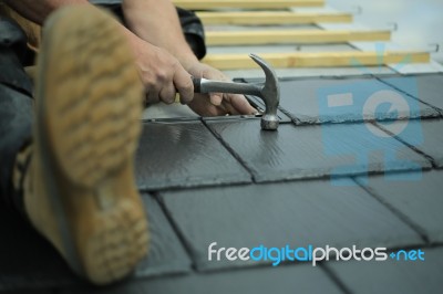 Tiler Laying Tiles On Roof Stock Photo