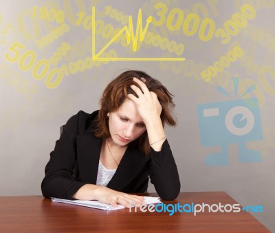 Tired Business Woman Sitting At The Table Stock Photo