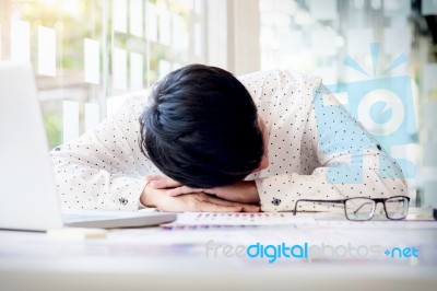 Tired Businessman Sleeping While Calculating Expenses At Desk I Stock Photo