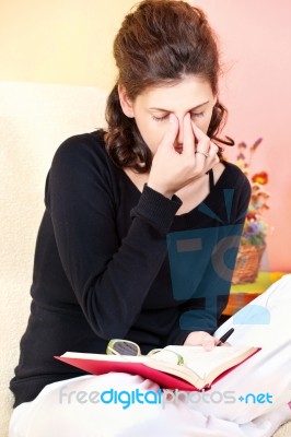 Tired Woman Of Reading A Book Stock Photo