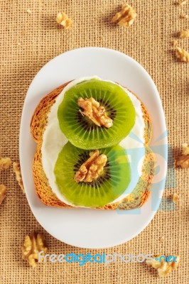 Toast With Kiwi, Cheese And Walnuts Stock Photo