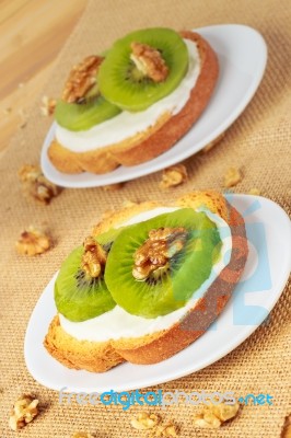 Toast With Kiwi, Cheese And Walnuts Stock Photo