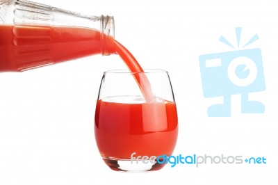 Tomato Juice Is Flowing Into A Glass Isolated On White Stock Photo