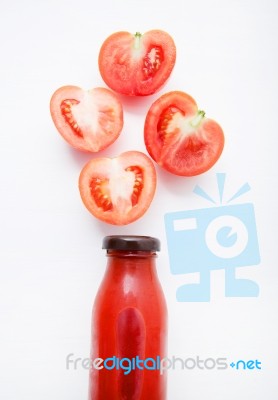 Tomatoes Juice In Bottle And Fresh Tomatoes Slices On White Wood… Stock Photo