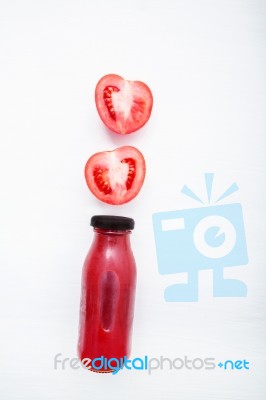 Tomatoes Juice In Bottle And Fresh Tomatoes Slices On White Wood… Stock Photo