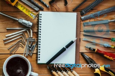 Tools Equipment With Coffee And Notebook On Wood Stock Photo