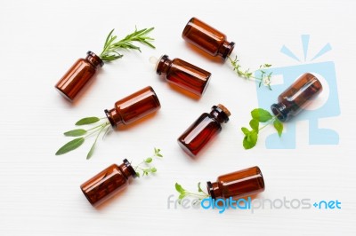 Top View, Bottle Of Essential Oil With Herbs Stock Photo