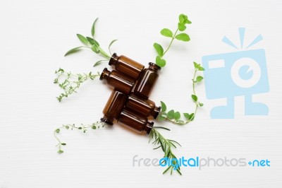 Top View, Bottle Of Essential Oil With Herbs Stock Photo