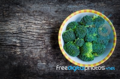 Top View. Fresh Green Broccoli On Plate Over Wooden Background Stock Photo