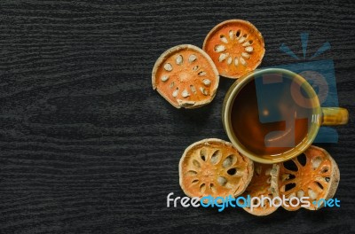 Top View Of Bael Dry And Glass Tea And Bael Juice On The Wooden Floor Stock Photo