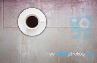 Top View Of Coffee Cup On Ceramic Tiles Wall Background Stock Photo