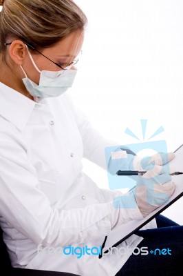 Top View Of Doctor With Writing Pad And Mask Stock Photo