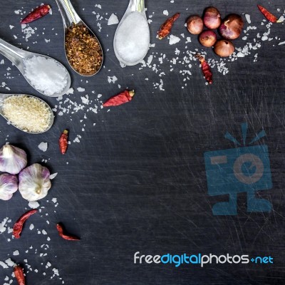 Top View Of Food Ingredients And Condiment On The Table, Ingredients And Seasoning On Dark Wooden Floor Stock Photo