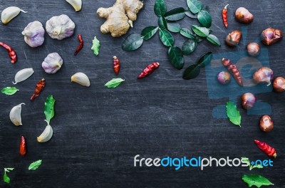 Top View Of Food Ingredients And Condiment On The Table, Ingredients And Seasoning On Dark Wooden Floor Stock Photo