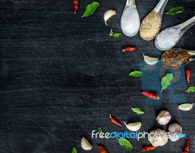 Top View Of Food Ingredients And Condiment On The Table, Ingredients And Seasoning On Dark Wooden Floor Stock Photo