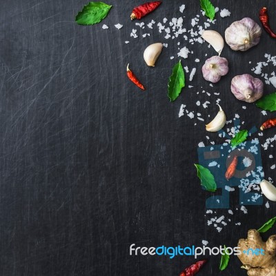 Top View Of Food Ingredients And Condiment On The Table, Ingredients And Seasoning On Dark Wooden Floor Stock Photo