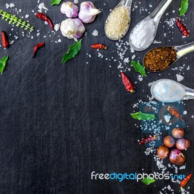 Top View Of Food Ingredients And Condiment On The Table, Ingredients And Seasoning On Dark Wooden Floor Stock Photo