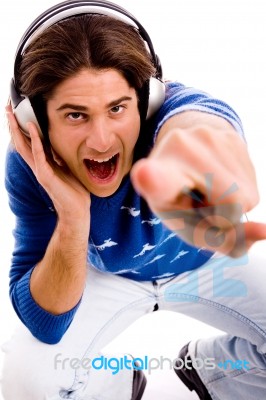 Top View Of Shouting Male Enjoying Music And Pointing Stock Photo