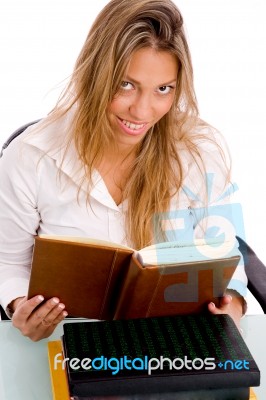 Top View Of Smiling Student Reading Book Stock Photo