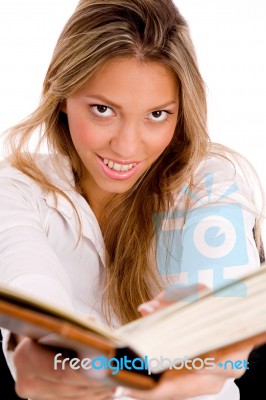 Top View Of Smiling Student With Book Looking At Camera Stock Photo