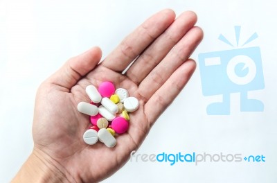 Top View Of The Pills On The Hand And White Background, A Hand Hold The Pills And Drug Stock Photo