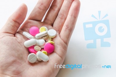 Top View Of The Pills On The Hand And White Background, A Hand Hold The Pills And Drug Stock Photo