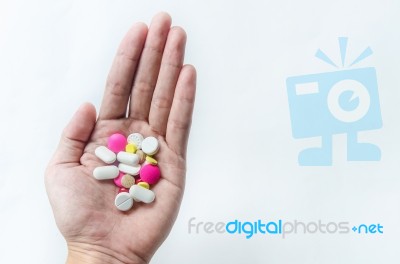 Top View Of The Pills On The Hand And White Background, A Hand Hold The Pills And Drug Stock Photo