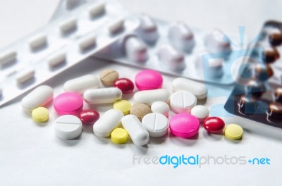 Top View Of The Pills On The White Background, Pack Of Tablet Drug And Capsule Pills On The Floor Stock Photo