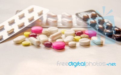 Top View Of The Pills On The White Background, Pack Of Tablet Drug And Capsule Pills On The Floor Stock Photo