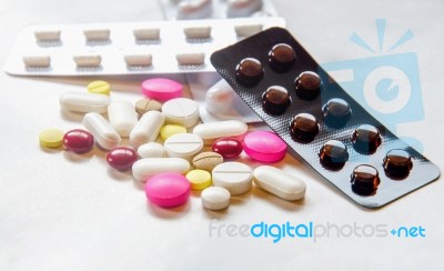 Top View Of The Pills On The White Background, Pack Of Tablet Drug And Capsule Pills On The Floor Stock Photo