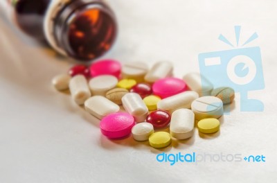 Top View Of The Pills On The White Background, The Drug And Capsule Pills On The Floor Stock Photo