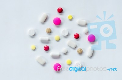 Top View Of The Pills On The White Background, The Drug And Capsule Pills On The Floor Stock Photo