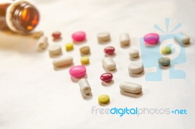 Top View Of The Pills On The White Background, The Drug And Capsule Pills On The Floor Stock Photo