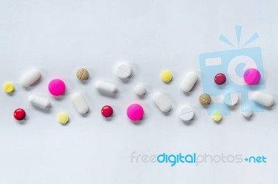 Top View Of The Pills On The White Background, The Drug And Capsule Pills On The Floor Stock Photo