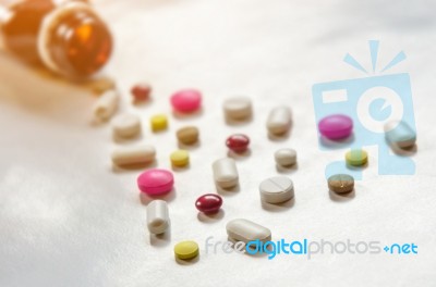 Top View Of The Pills On The White Background, The Drug And Capsule Pills On The Floor Stock Photo